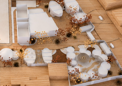 Maqueta de un predio con volúmenes blancos, cúpulas y pabellones circulares, árboles secos, rodeado de manzanas de madera y con una placa de datos al frente.